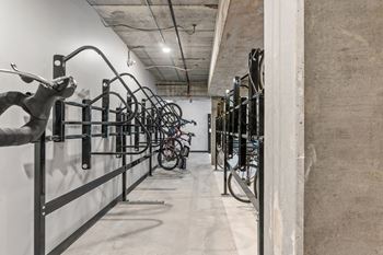 A bike rack with many bicycles parked in it.